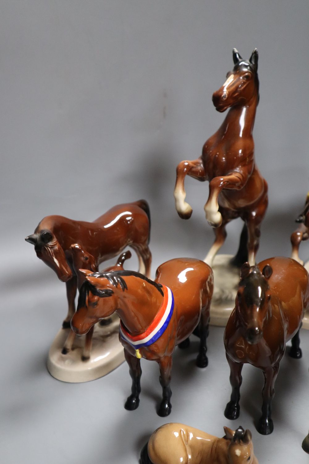 A collection of four various Beswick model horses including Highland, Another Bunch and Another Star, and three Continental horse model